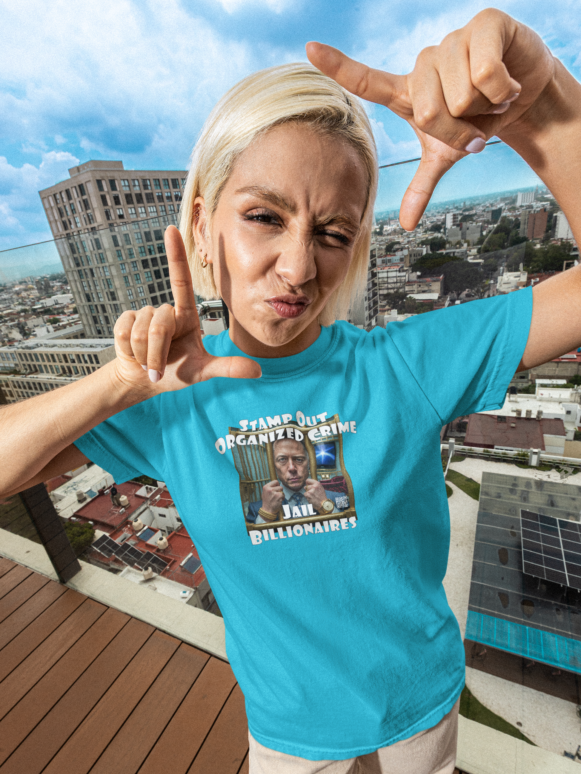 Person wearing a blue Stamp Out Organized Crime-Jail Billionaires Activist T-shirt posing with thumbs up.