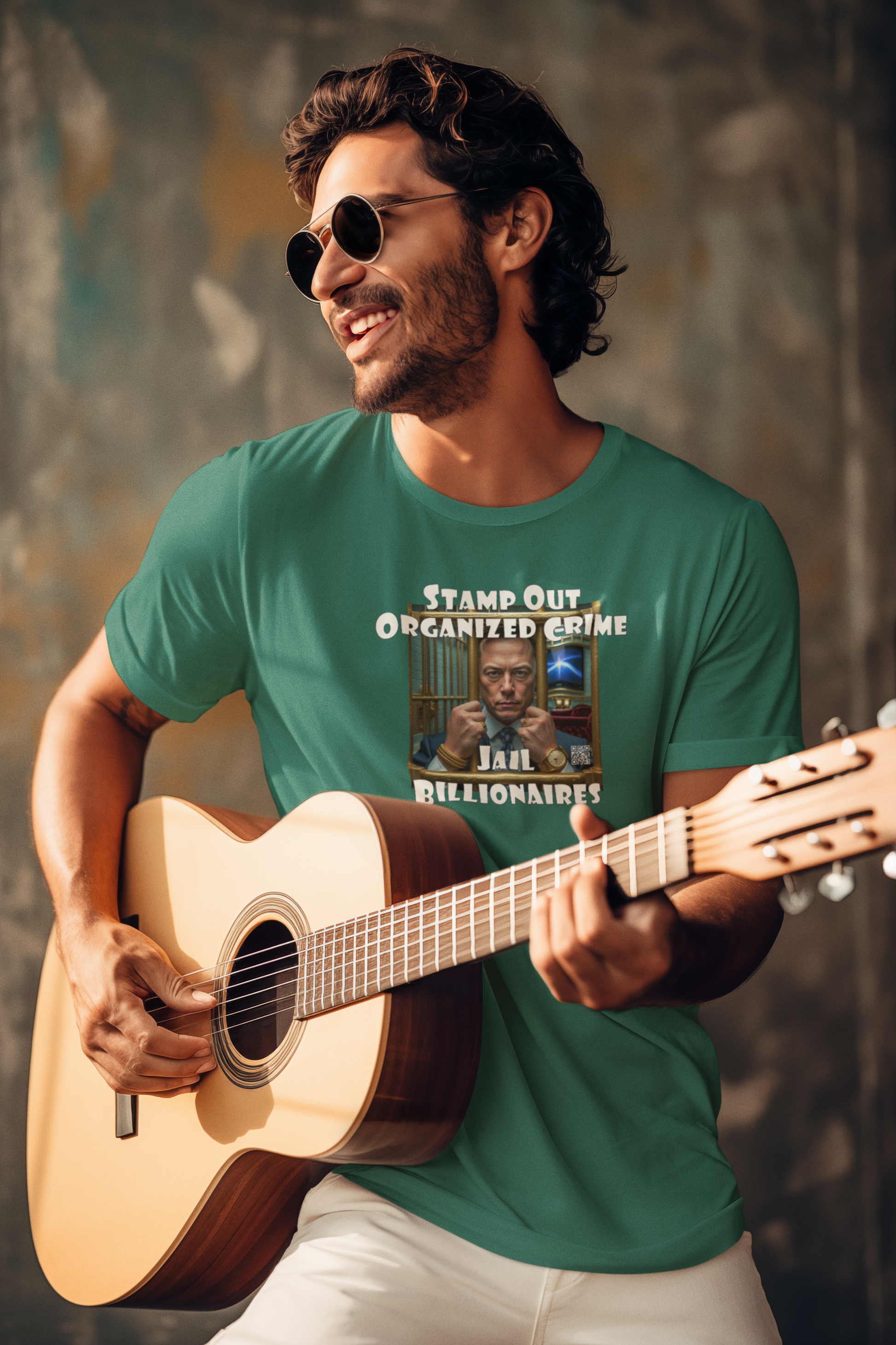 Man smiling while playing guitar in a Stamp Out Organized Crime-Jail Billionaires Activist T-shirt.