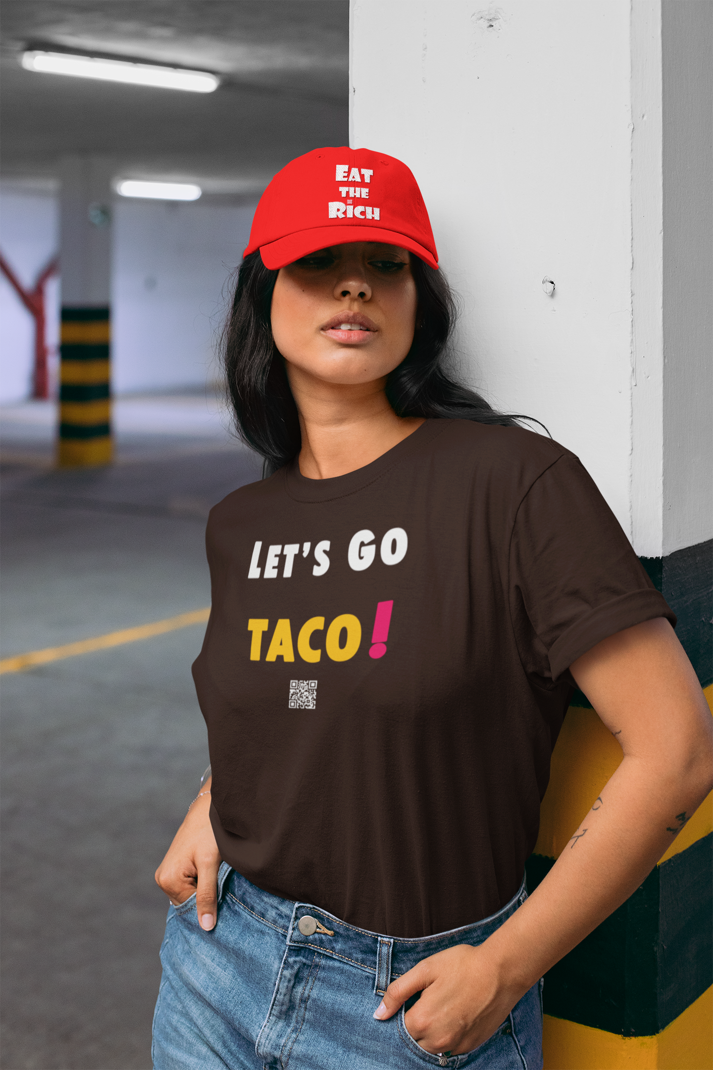 Model wearing TACO Activist TShirt with playful design, featuring the phrase 'Let's Go TACO!' in a parking garage setting.