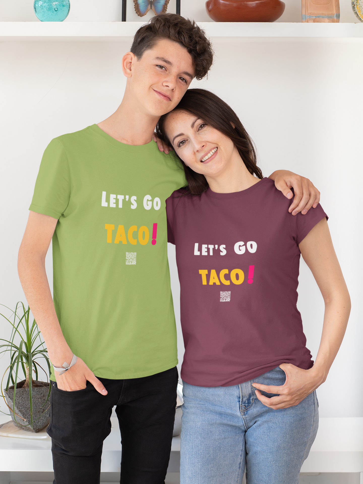Two people wearing TACO Activist TShirts, celebrating with bright designs, in a cheerful atmosphere.