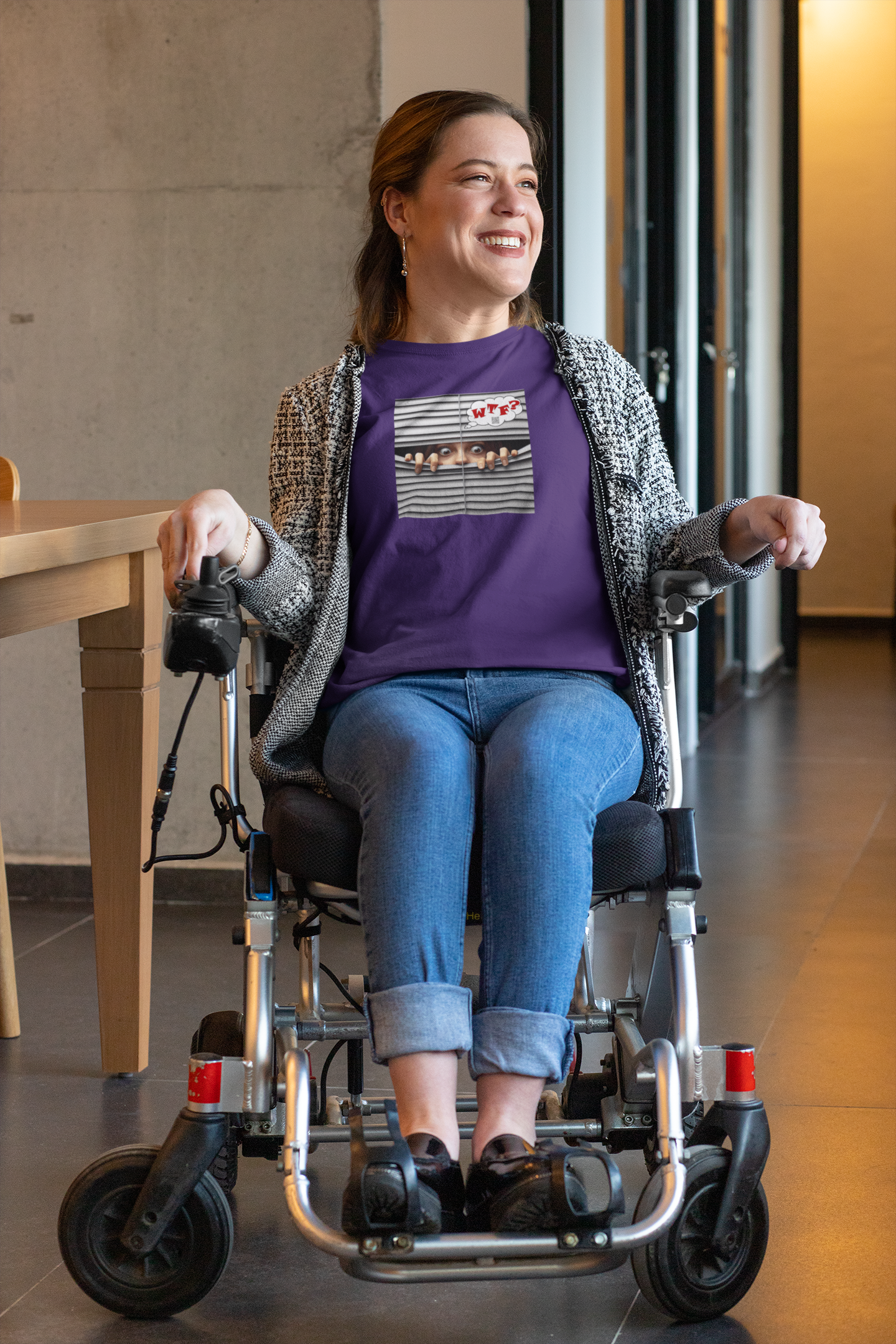 WTF White Female Model Activist TShirt worn by a woman in a wheelchair, smiling in a bright indoor setting.