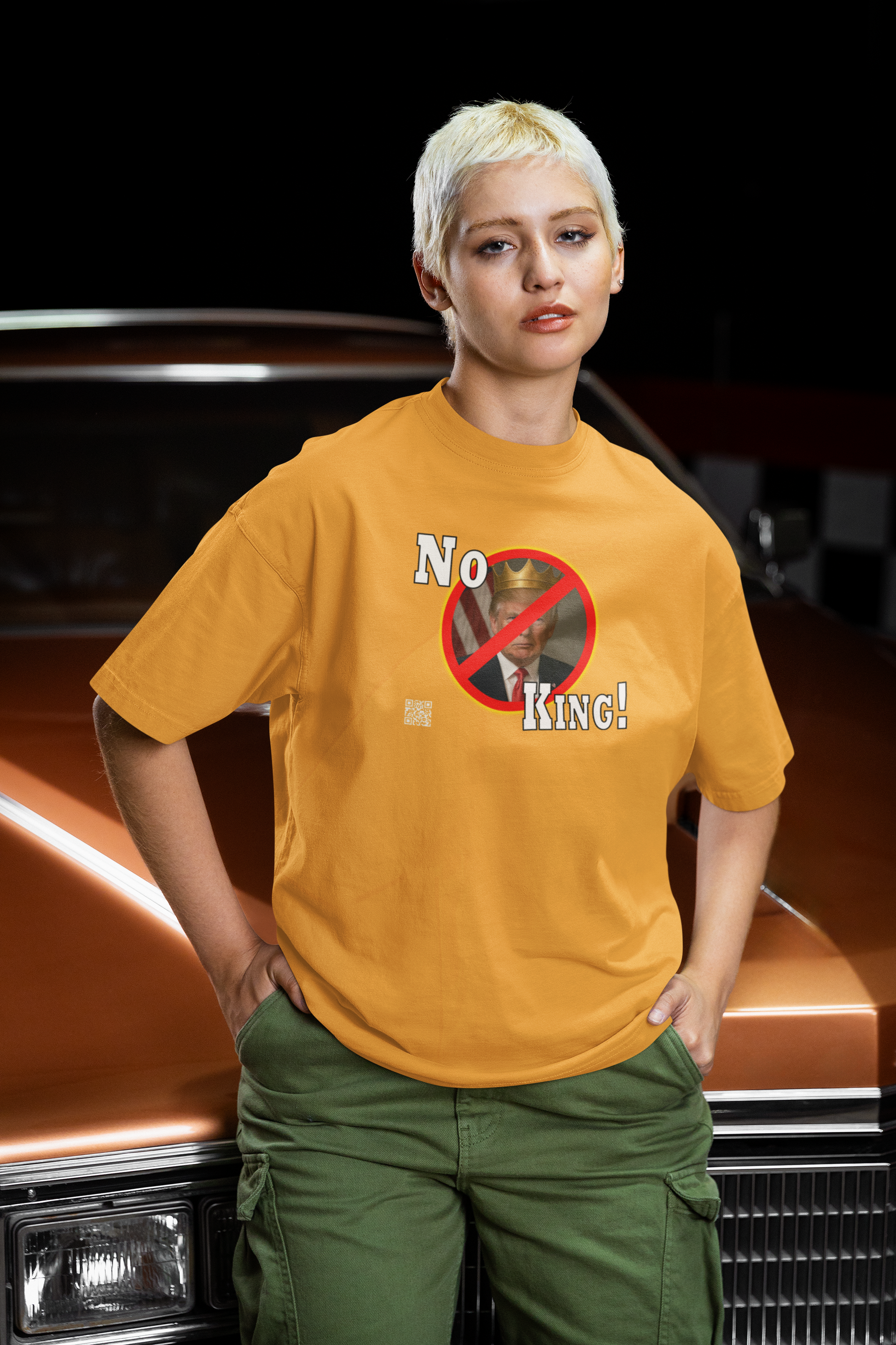Model wearing No King Activist TShirt in yellow, featuring a bold anti-monarchy graphic.
