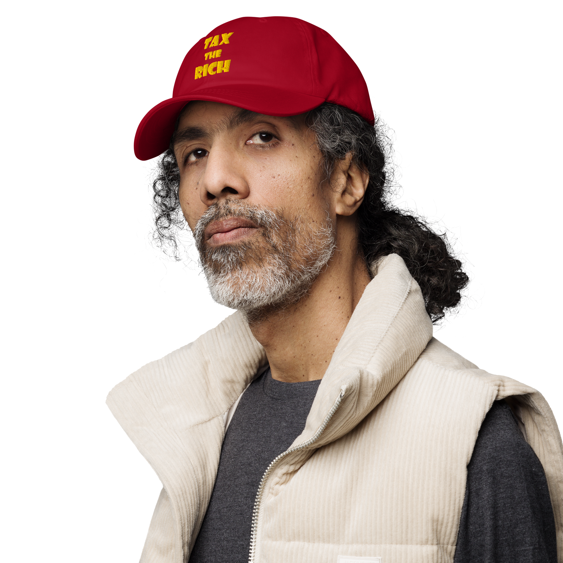 Portrait of a man wearing a red TAX THE RICH — Embroidered Dad Hat and beige vest.