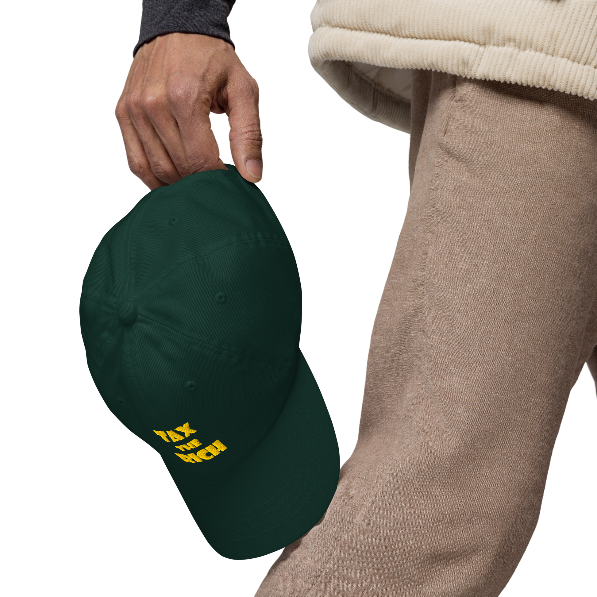 TAX THE RICH — Embroidered Dad Hat being held, featuring bold text design on a dark green background.