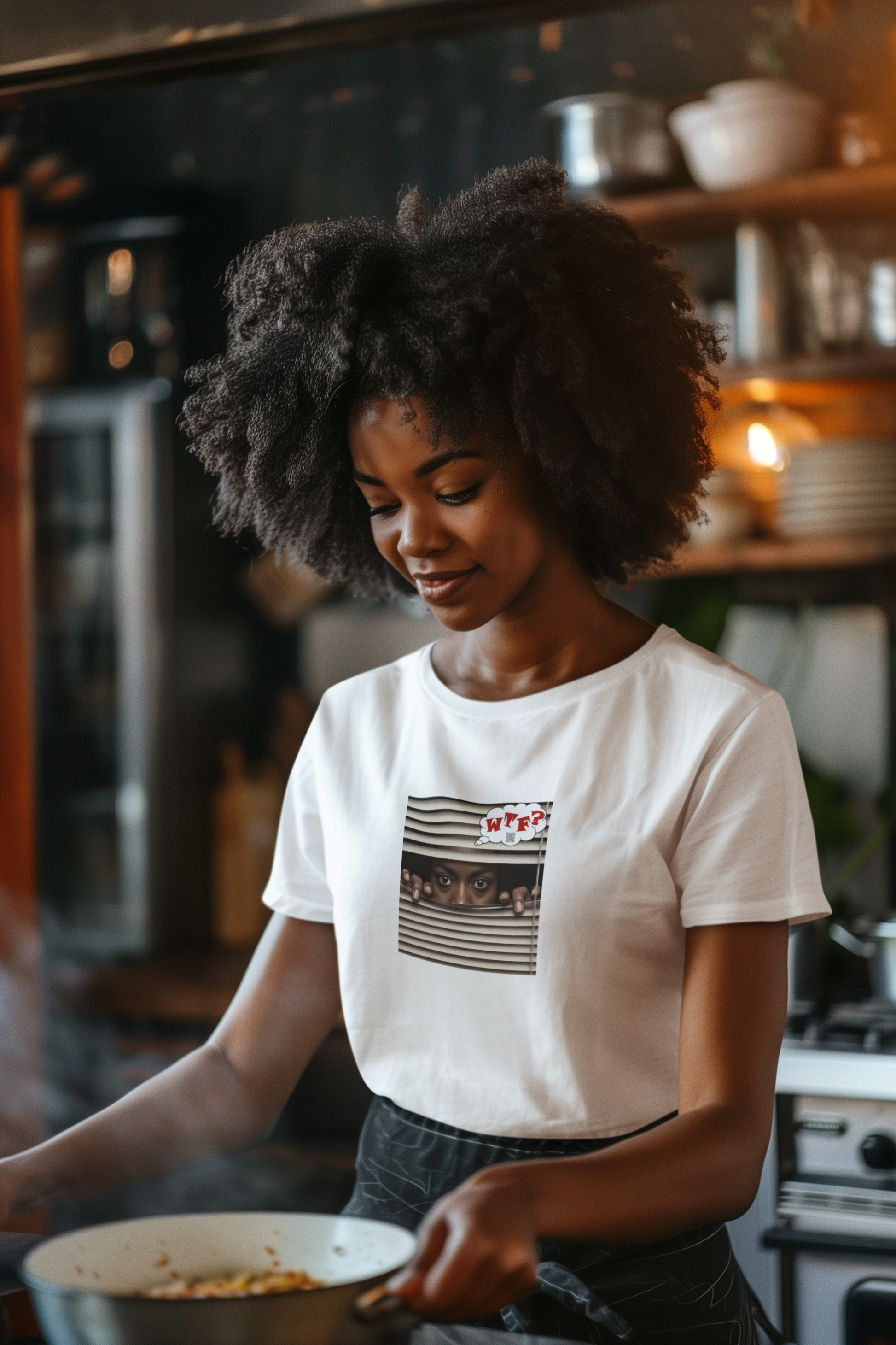 WTF Activist T-Shirt Black Female Model worn by a smiling woman cooking in a stylish kitchen.