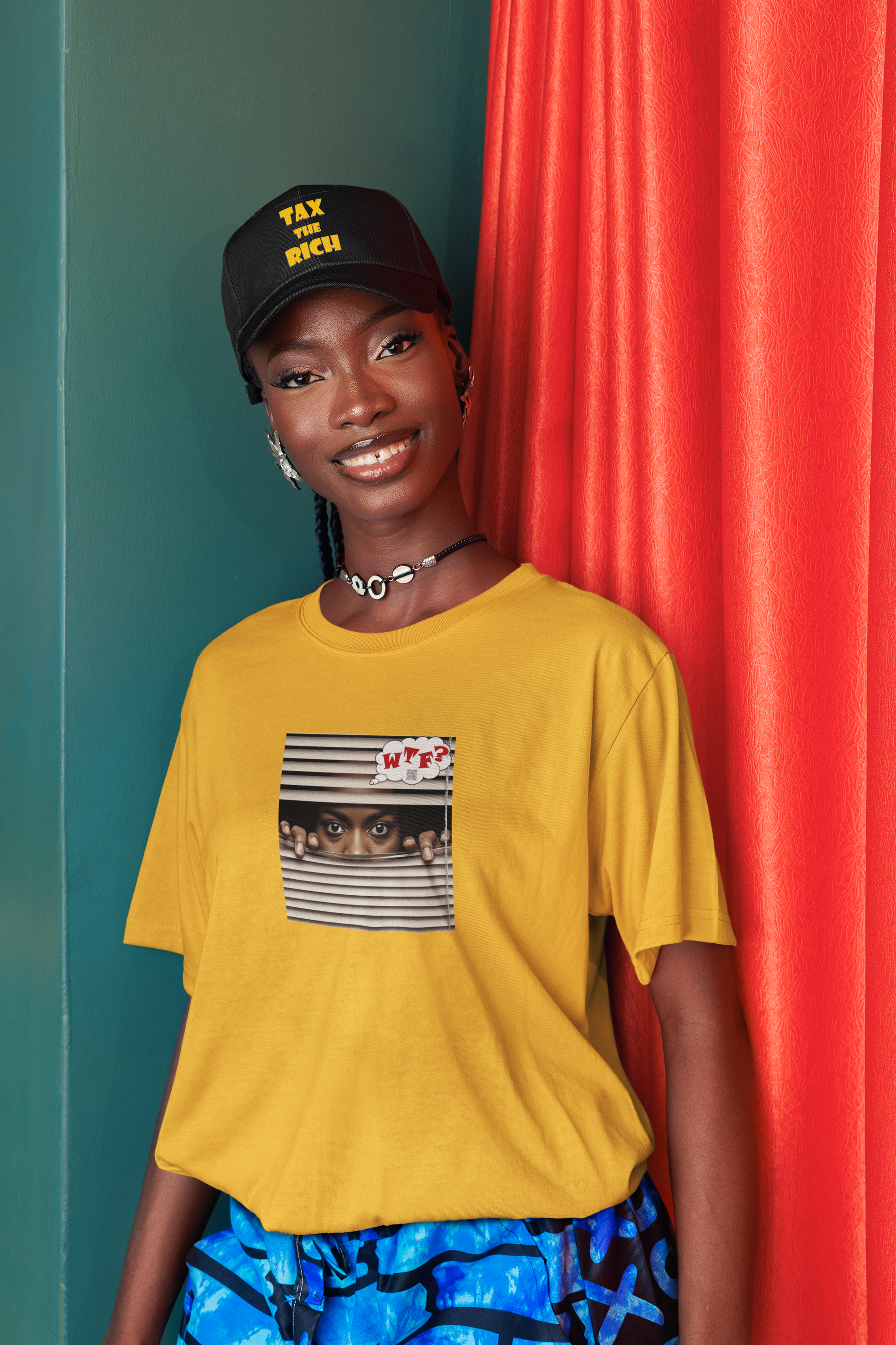 WTF Activist T-Shirt Black Female Model worn by a smiling woman with a yellow tee and black cap, standing against a colorful backdrop.