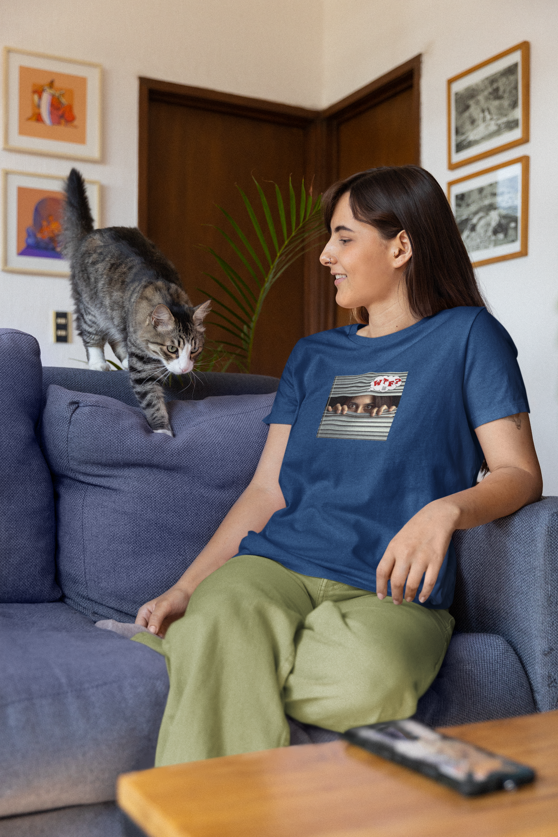 WTF Hispanic female activist t-shirt worn by a woman with a cat at home.