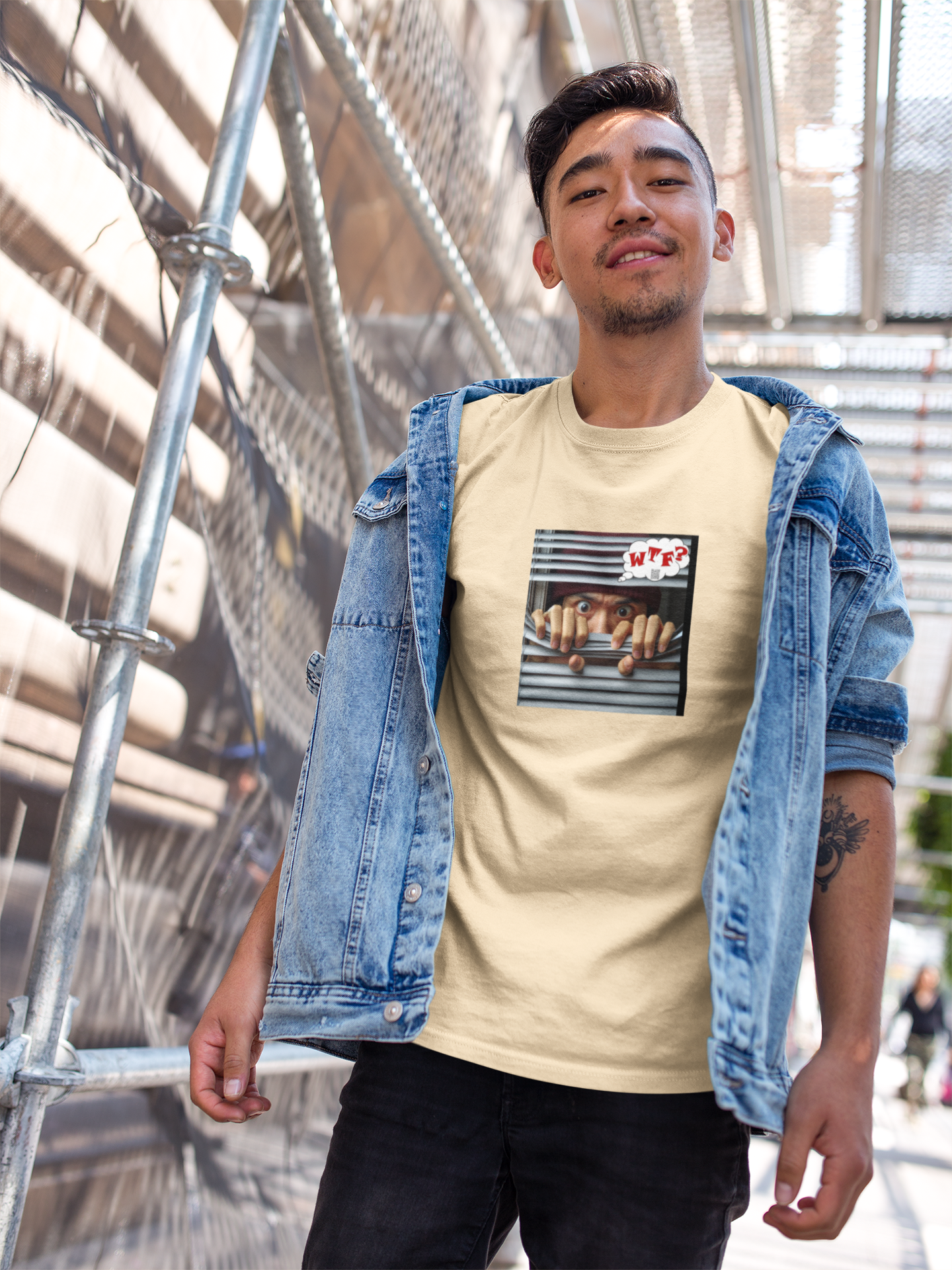 Asian male model wearing WTF activist t-shirt for Asian male model against an urban backdrop.