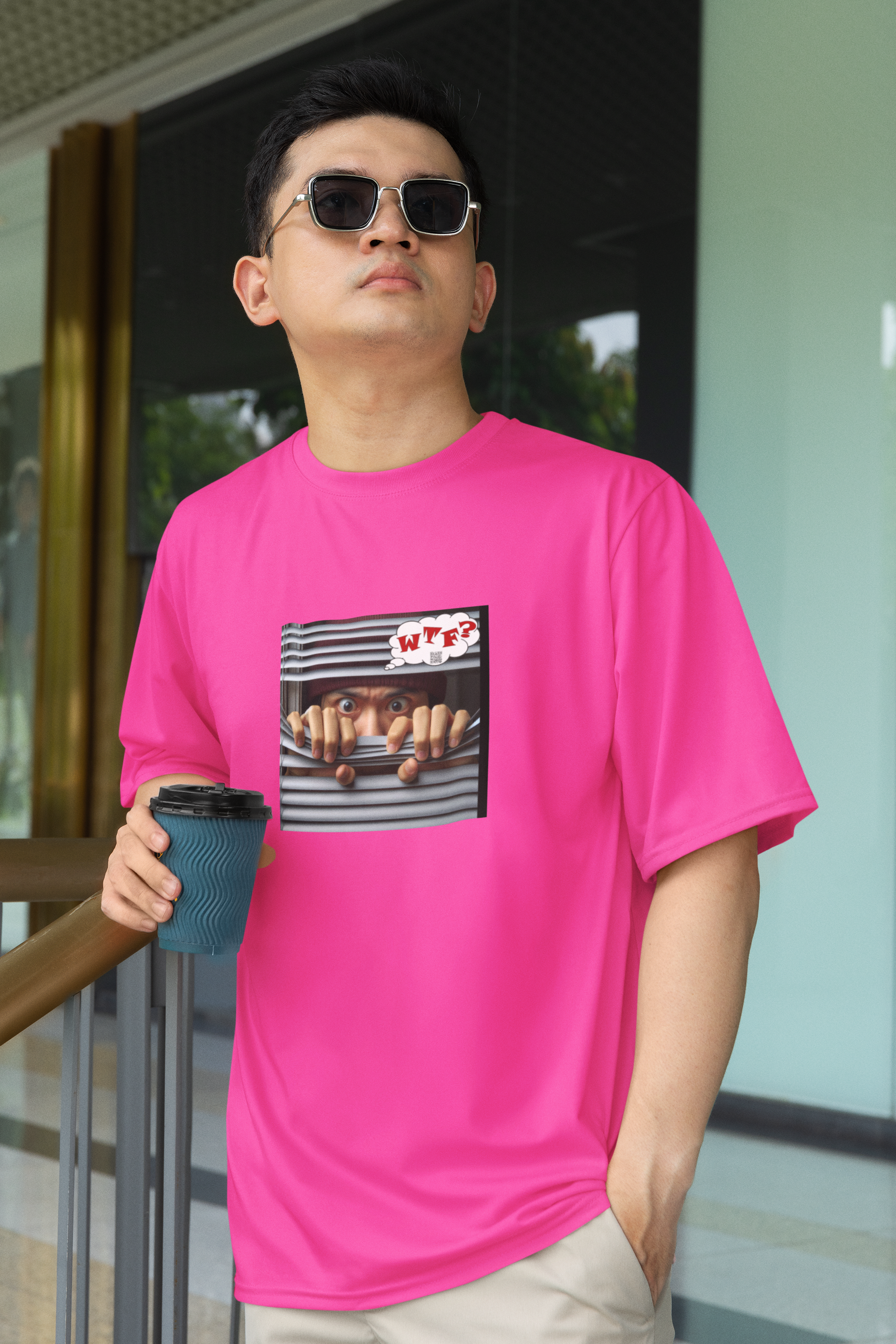 WTF activist t-shirt for Asian male model worn by a man holding a coffee cup outdoors.