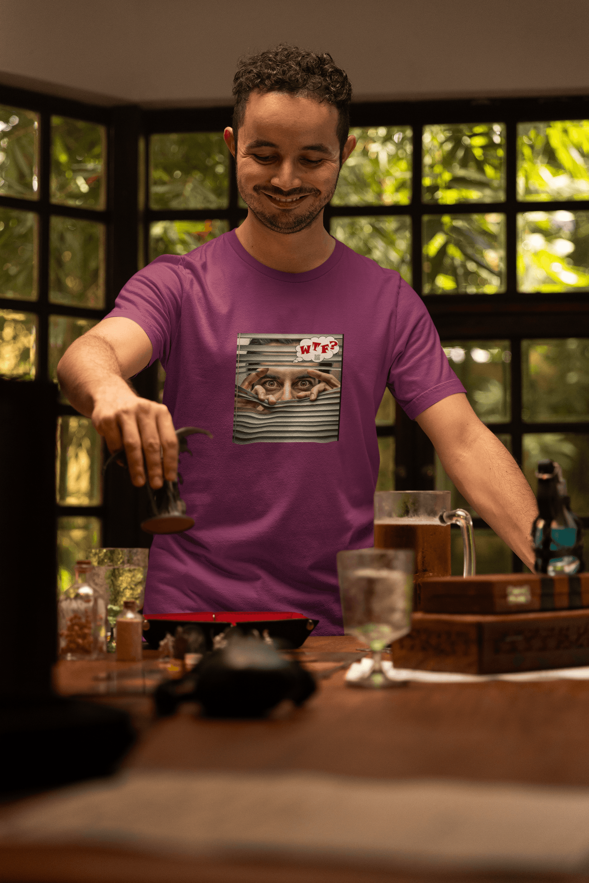 WTF activist t-shirt Hispanic male model smiling while pouring a drink in a cozy setting.
