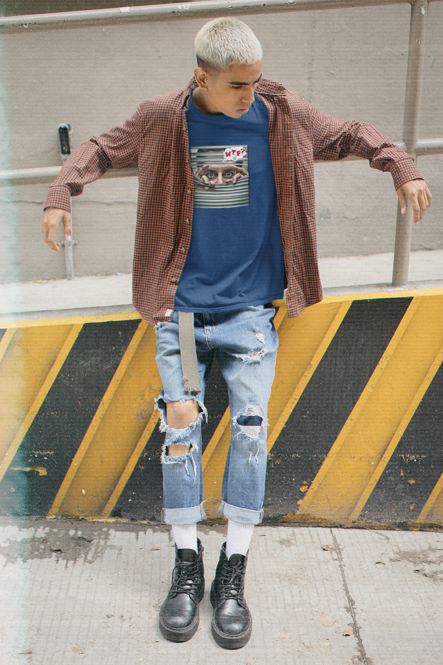 WTF activist t-shirt Hispanic male model worn by a young male model with ripped jeans and stylish boots.