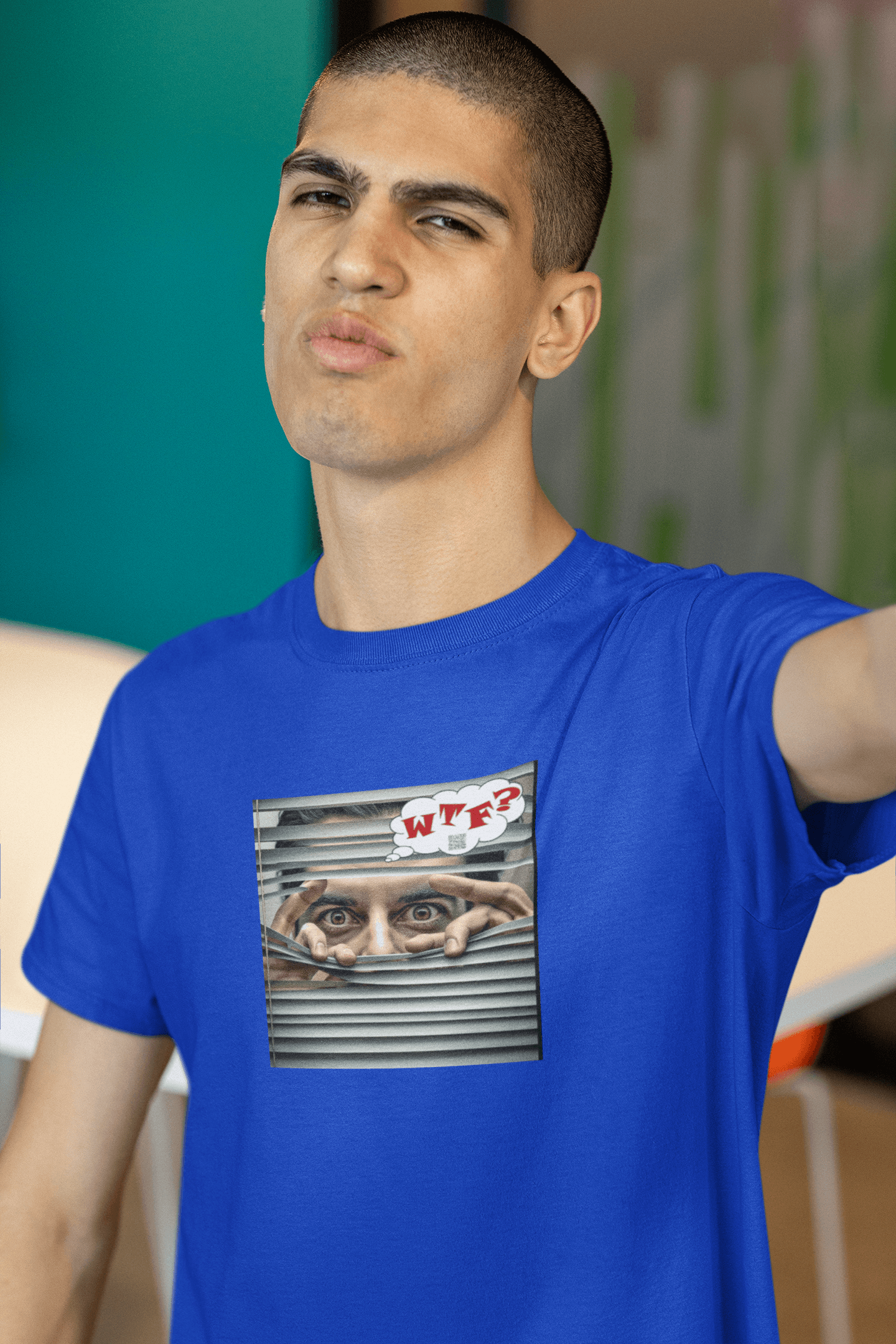 WTF activist t-shirt Hispanic male model wearing a blue shirt with a graphic design featuring eyes peering through a shutter.