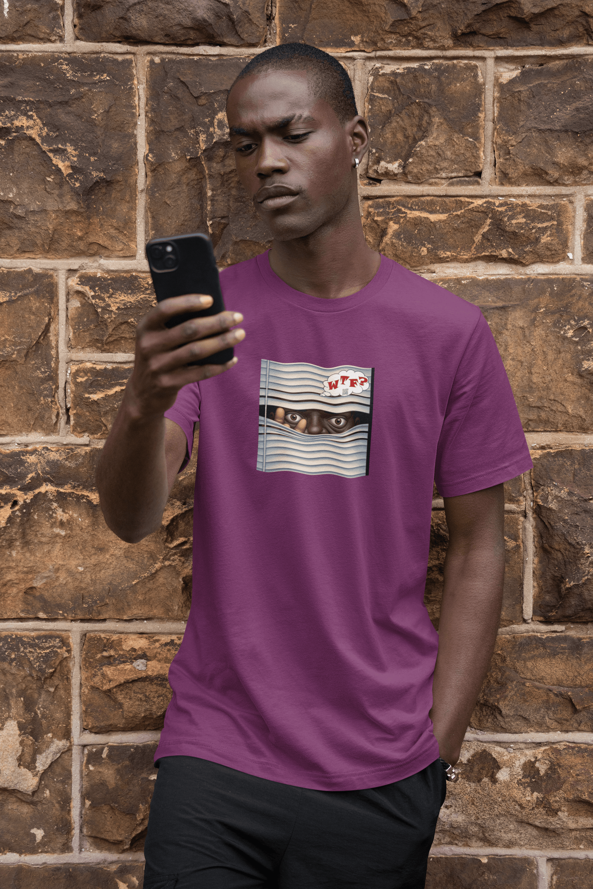 Black male model wearing WTF Activist T-Shirt - Black Male Model Designed by jthomascrowne while looking at phone.