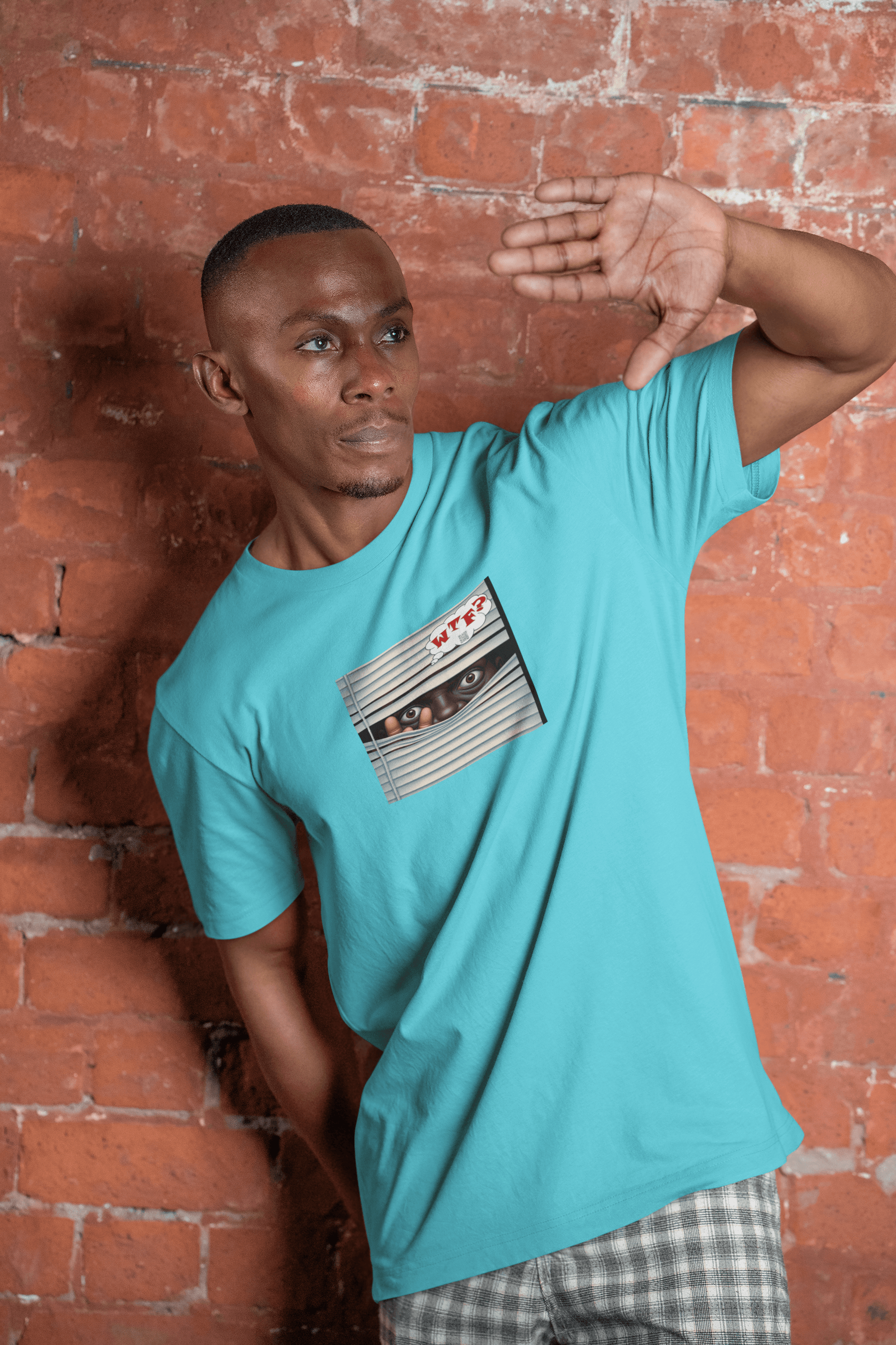 WTF Activist T-Shirt - Black Male Model Designed by jthomascrowne in turquoise, posed against a rustic brick wall.