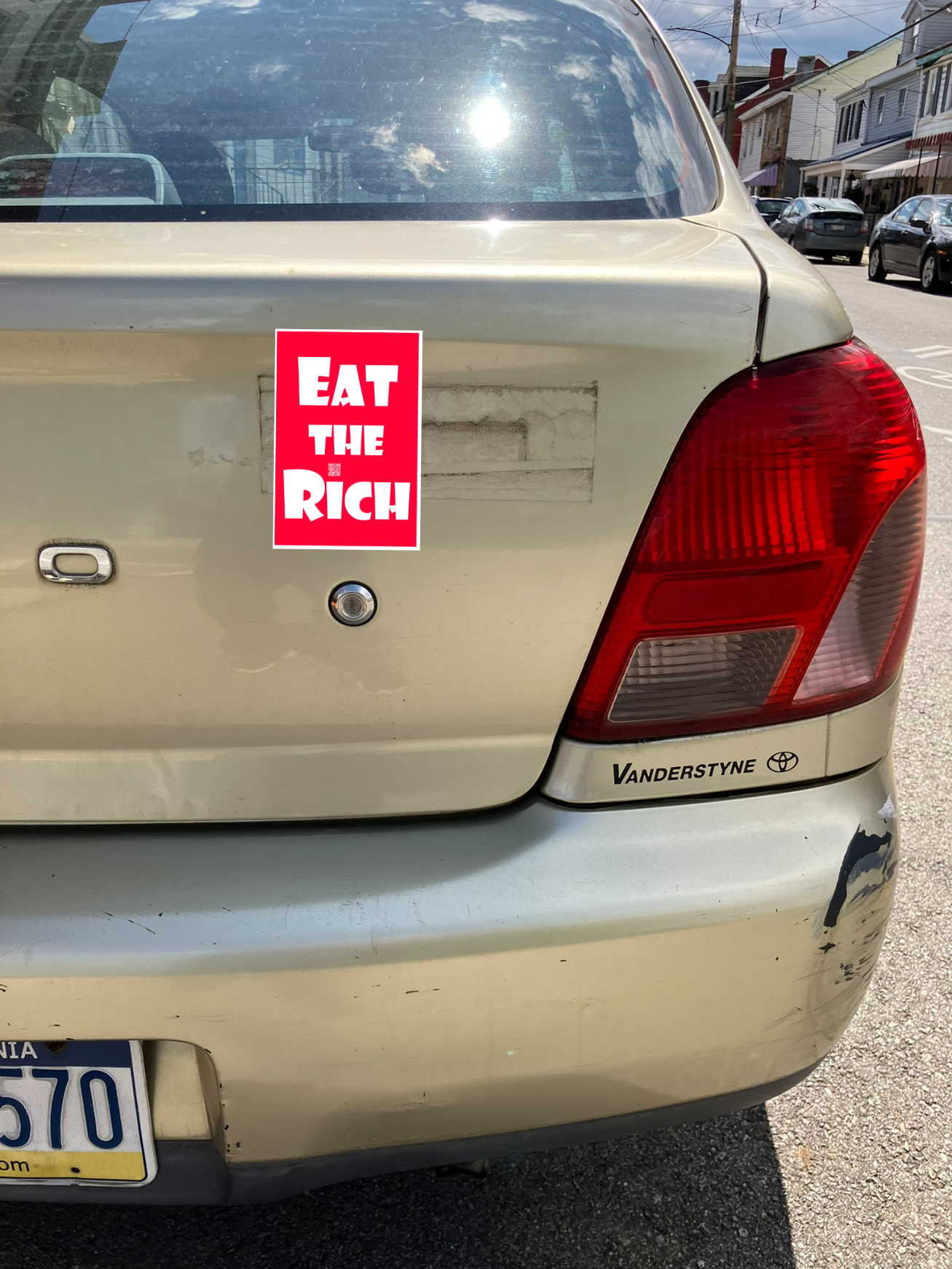 4" x 5" red magnet with white Eat the Rich lettering, on the back of a gold car