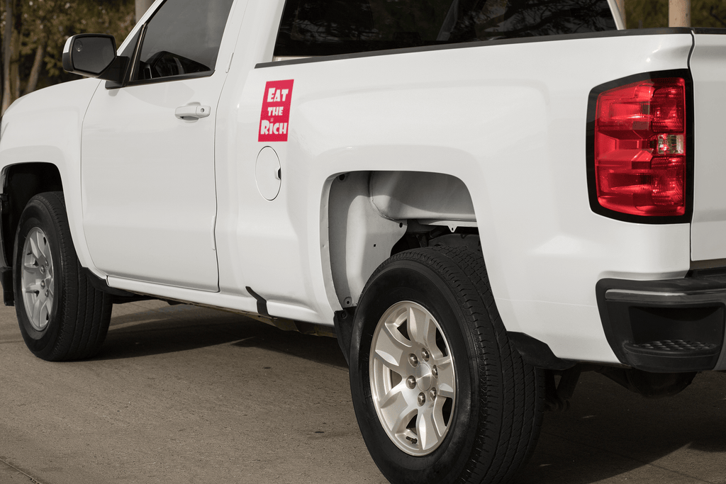 4" x 5" red magnet with white Eat the Rich lettering, on the side of a white pickup truck near the door