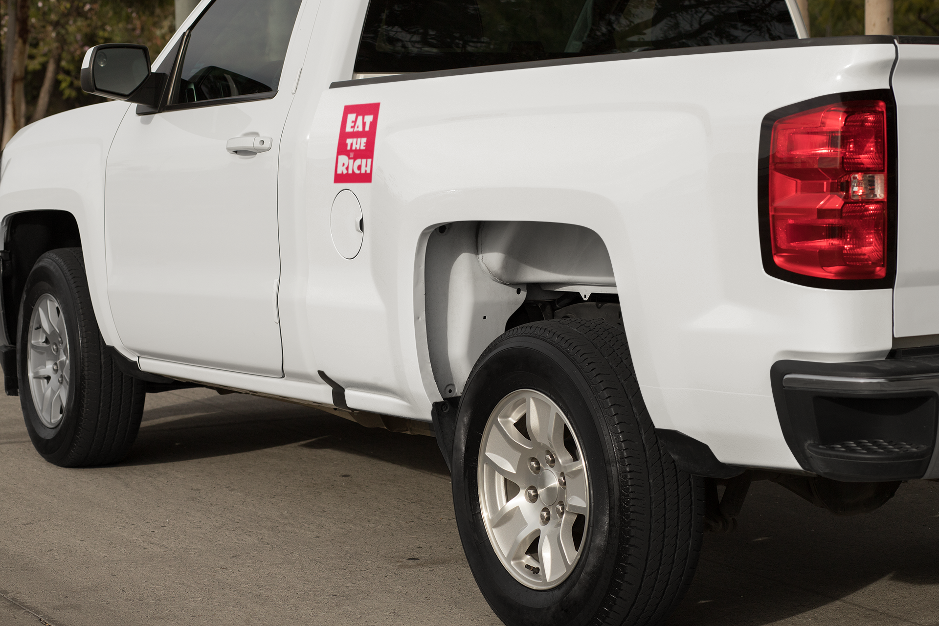 4" x 5" red magnet with white Eat the Rich lettering, on the side of a white pickup truck near the door