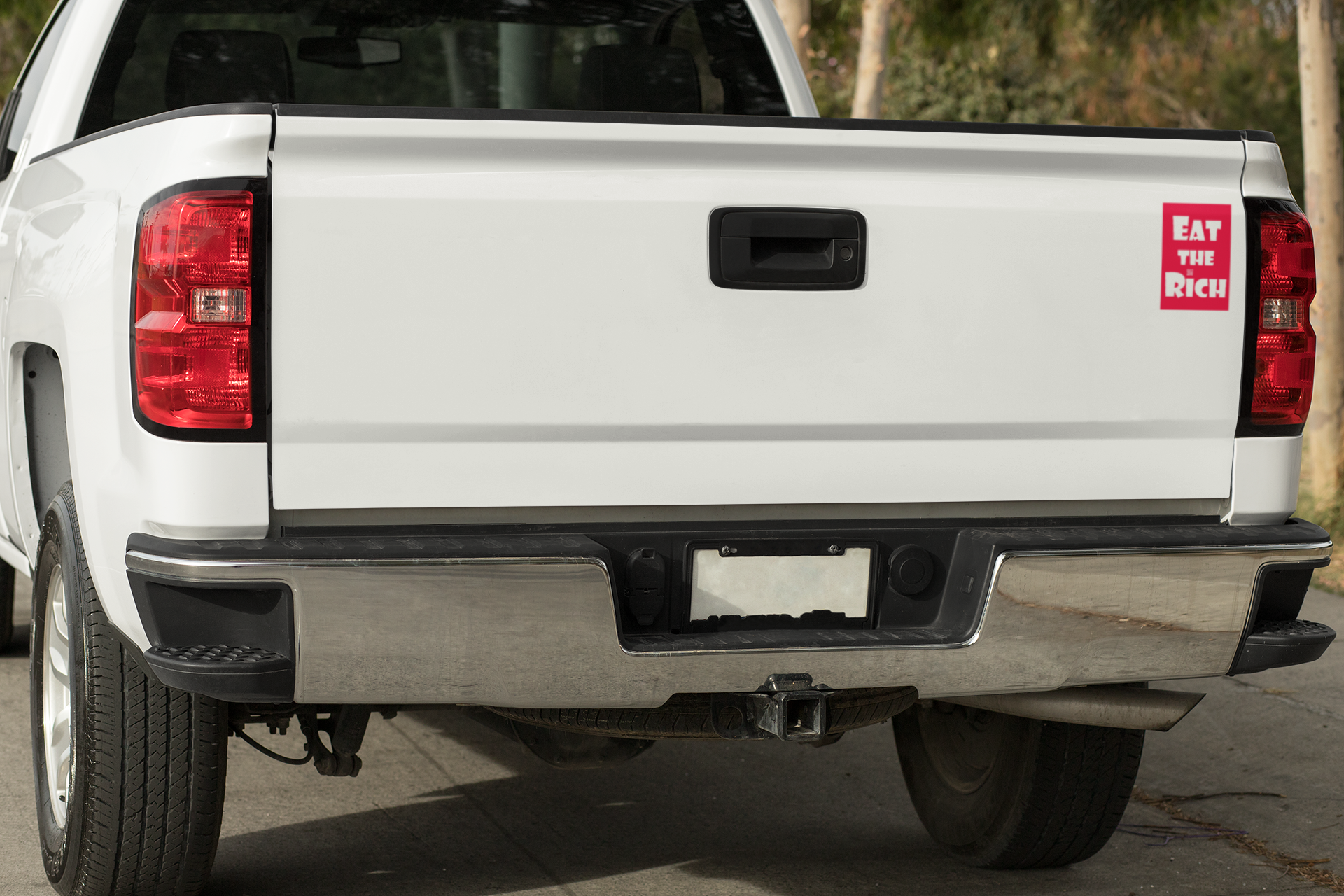 4" x 5" red magnet with white Eat the Rich lettering, on the back of a white pickup truck